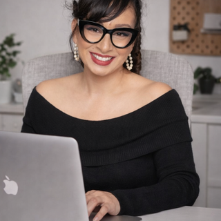 Creative designer at CUCU Design Studio working on editable Canva templates for memorial and business designs